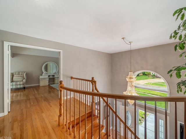 420 Ford Ln, Bartlett, IL 60103 - corridor featuring an upstairs landing, light wood-style floors, a chandelier, and baseboards