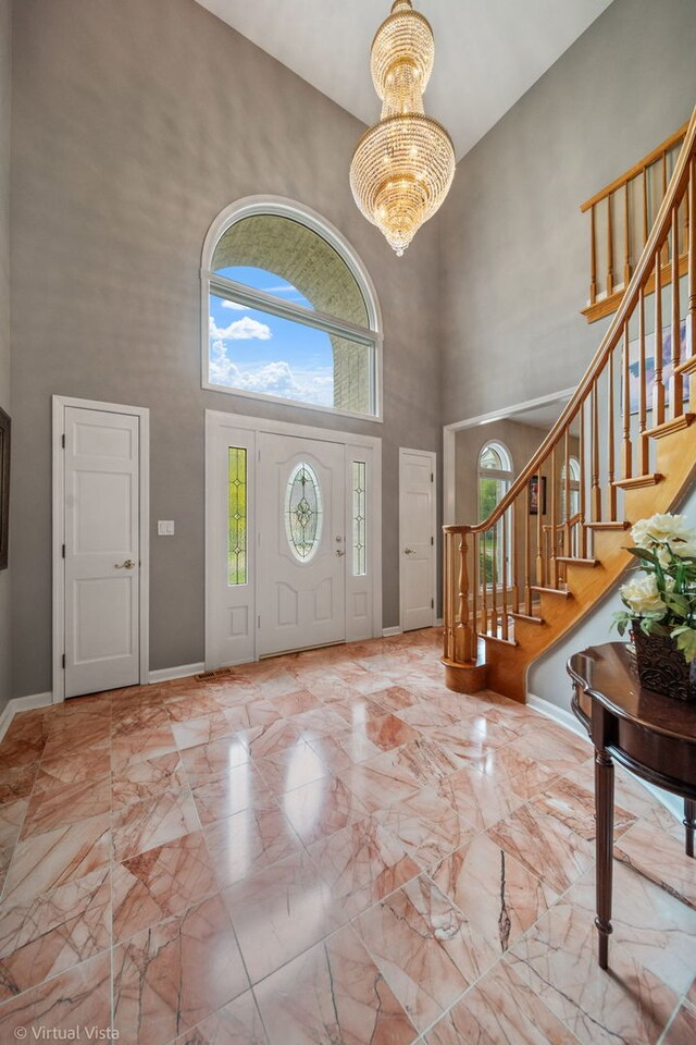 420 Ford Ln, Bartlett, IL 60103 - foyer featuring a high ceiling, stairs, a chandelier, baseboards, and marble finish floors