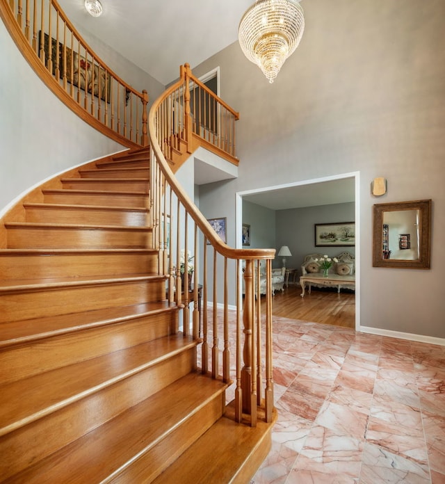 420 Ford Ln, Bartlett, IL 60103 - stairs with baseboards, a high ceiling, a chandelier, and marble look tiles