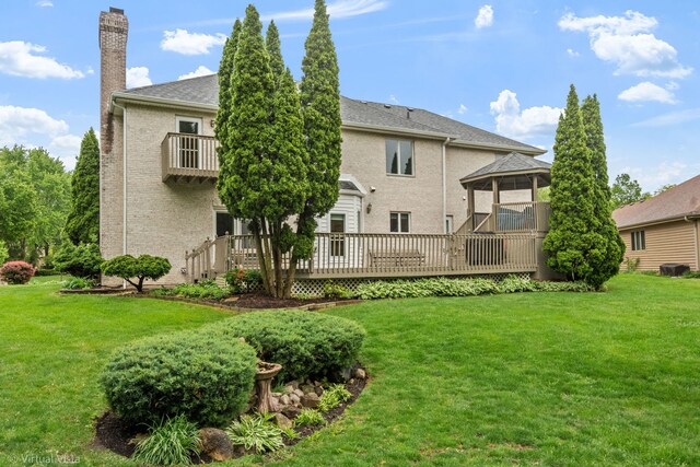 420 Ford Ln, Bartlett, IL 60103 - back of property featuring a chimney, a lawn, brick siding, and a wooden deck