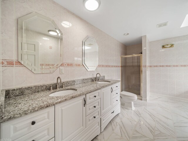 420 Ford Ln, Bartlett, IL 60103 - bathroom with tile walls, a shower stall, double vanity, and toilet