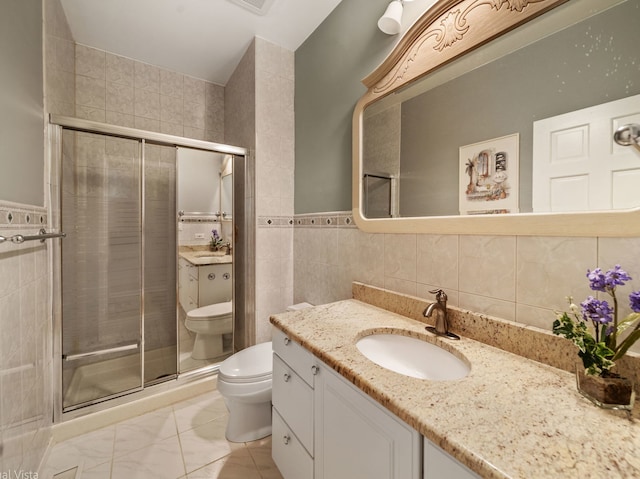 420 Ford Ln, Bartlett, IL 60103 - bathroom featuring toilet, vanity, tile walls, and a stall shower