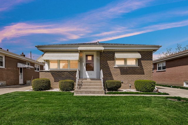 5112 N Oneida Ave, Norridge, IL 60706 - view of front facade featuring brick siding, a front lawn, and entry steps