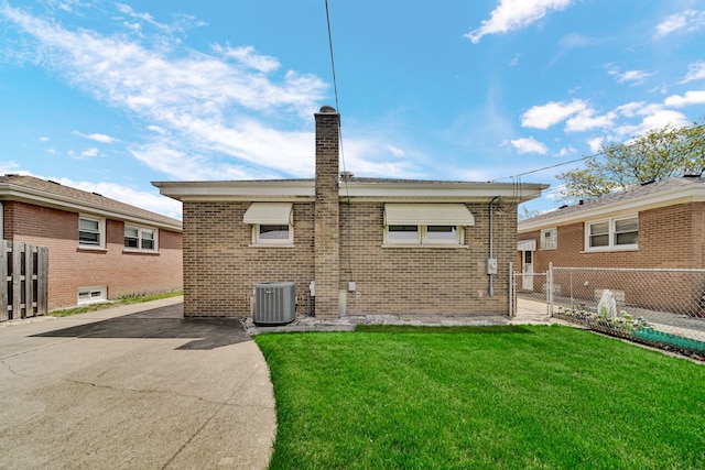 5112 N Oneida Ave, Norridge, IL 60706 - back of house featuring cooling unit, a chimney, and brick siding