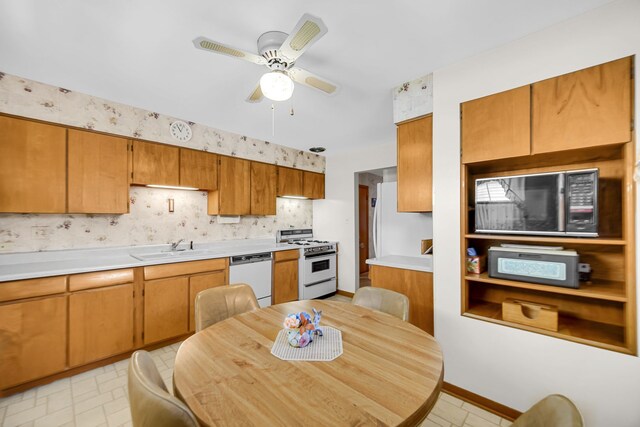 5112 N Oneida Ave, Norridge, IL 60706 - kitchen featuring white appliances, a sink, light countertops, brown cabinets, and a ceiling fan