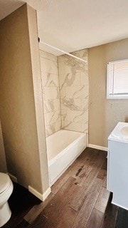 812 W Monroe St, Bloomington, IL 61701 - full bathroom featuring toilet, wood finished floors, vanity,  shower combination, and baseboards