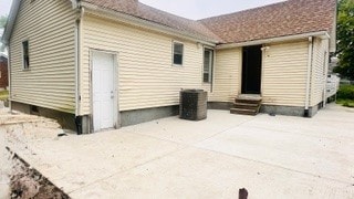 812 W Monroe St, Bloomington, IL 61701 - rear view of house with entry steps, a patio, and central AC unit