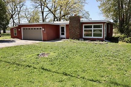 1803 Orchard Ln, Mchenry, IL 60050 - single story home featuring a garage, a front lawn, driveway, and a chimney