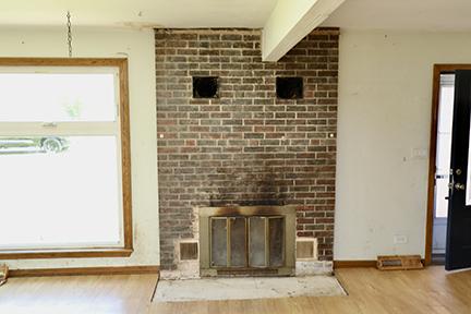 1803 Orchard Ln, Mchenry, IL 60050 - unfurnished living room featuring wood finished floors, baseboards, and a fireplace