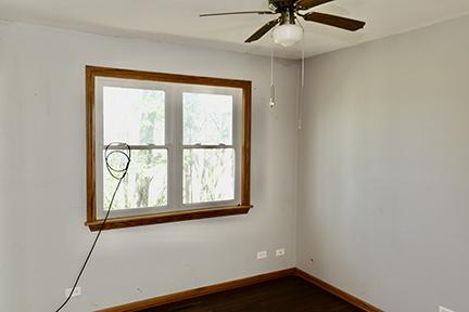 1803 Orchard Ln, Mchenry, IL 60050 - unfurnished room with healthy amount of natural light, baseboards, dark wood-style floors, and ceiling fan