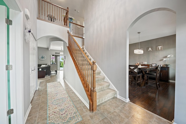 2274 Scotsglen Dr, New Lenox, IL 60451 - entrance foyer featuring arched walkways, a high ceiling, stairs, and baseboards