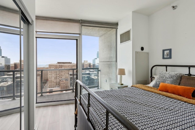 611 S Wells St Unit 2801, Chicago, IL 60607 - bedroom with expansive windows, a city view, and wood finished floors