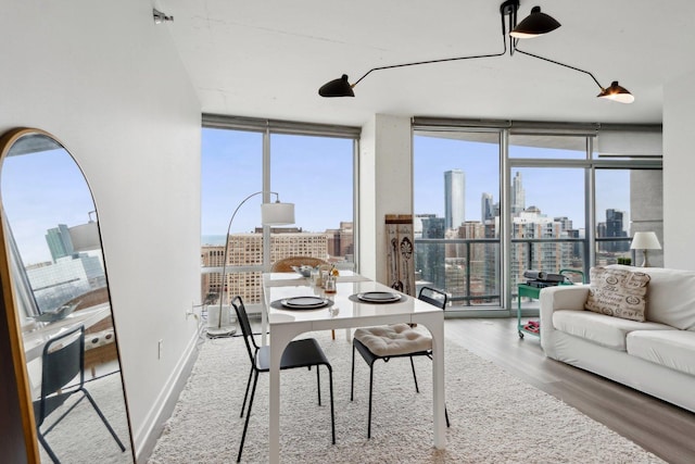 611 S Wells St Unit 2801, Chicago, IL 60607 - dining room featuring expansive windows, a skyline view, and wood finished floors