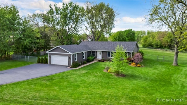single story home with driveway, an attached garage, and a shingled roof