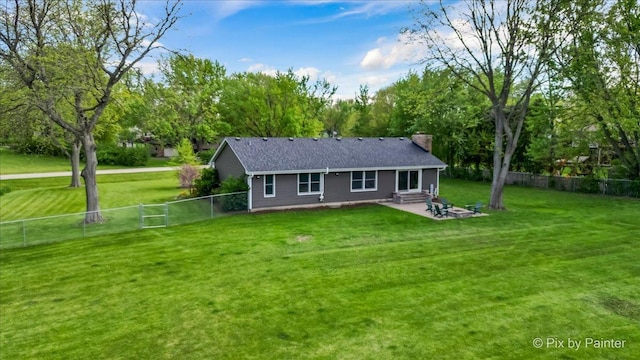 back of property with a chimney, entry steps, a patio, and view of scattered trees