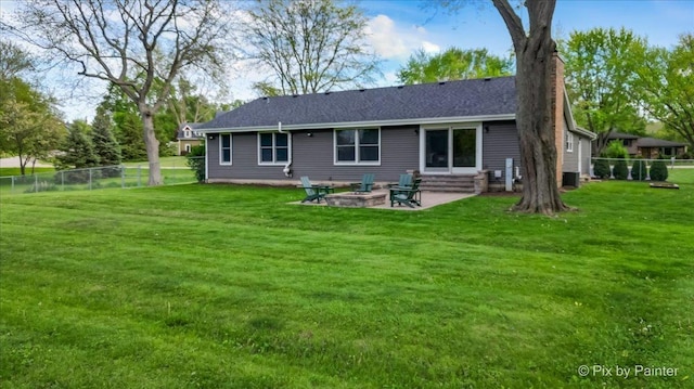 back of house with a patio area, a chimney, central air condition unit, and roof with shingles