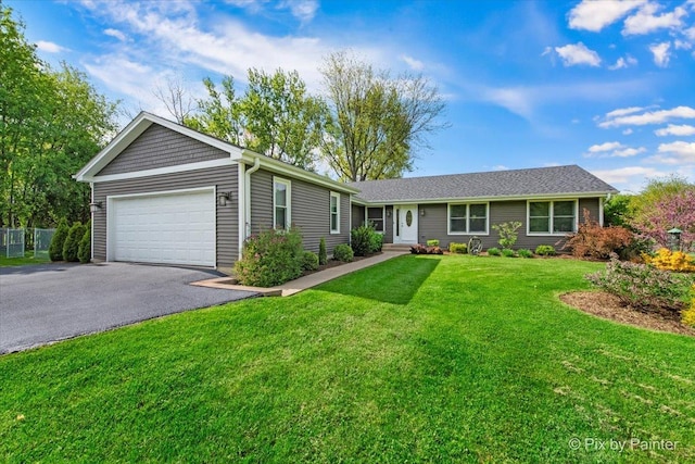 ranch-style house featuring driveway and an attached garage