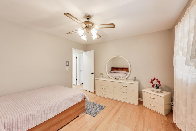 bedroom with light wood-type flooring and a ceiling fan