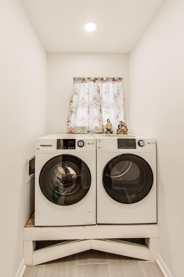 laundry area with separate washer and dryer, baseboards, and recessed lighting
