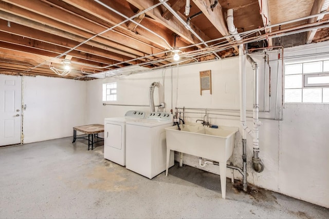 basement with washing machine and dryer and a sink