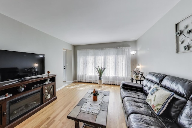 living area featuring wood finished floors and baseboards
