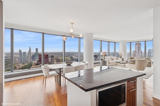 60 E Monroe St Unit 6203, Chicago, IL 60603 - kitchen featuring built in microwave, dark countertops, a view of skyline, and healthy amount of natural light