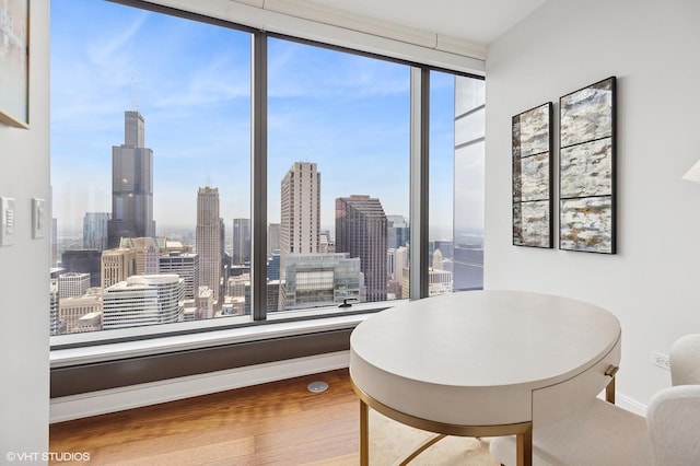 60 E Monroe St Unit 6203, Chicago, IL 60603 - dining space with wood finished floors, a skyline view, and baseboards