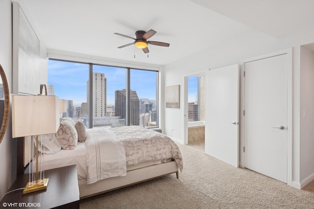 60 E Monroe St Unit 6203, Chicago, IL 60603 - carpeted bedroom with a skyline view, ensuite bathroom, and a ceiling fan