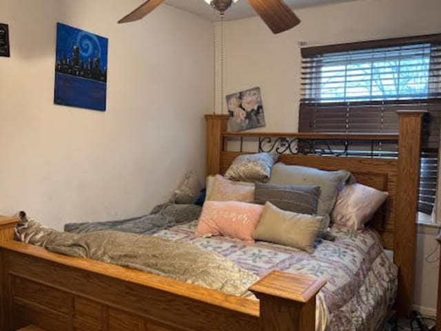 bedroom featuring beam ceiling and a ceiling fan