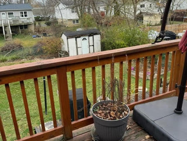 wooden deck with a storage unit and an outdoor structure