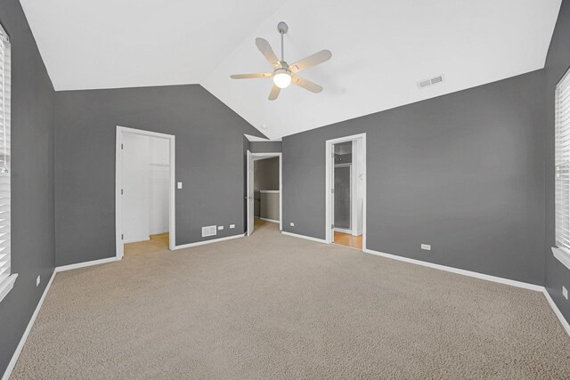 62 E Emma Ct, Palatine, IL 60067 - unfurnished bedroom featuring a walk in closet, lofted ceiling, baseboards, carpet, and a ceiling fan