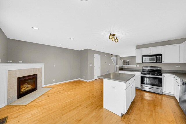 62 E Emma Ct, Palatine, IL 60067 - kitchen with stainless steel appliances, a kitchen island, dark countertops, light wood finished floors, and recessed lighting