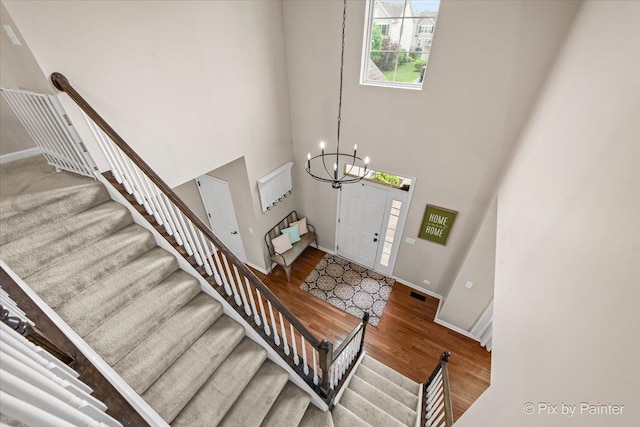 8926 Cook Way, Huntley, IL 60142 - foyer entrance featuring a chandelier, wood finished floors, a towering ceiling, stairway, and baseboards