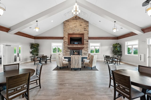 8926 Cook Way, Huntley, IL 60142 - dining area with healthy amount of natural light, a fireplace, light wood-type flooring, a chandelier, and high vaulted ceiling