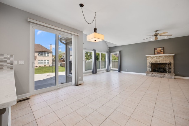 9231 N Natchez Ave, Morton Grove, IL 60053 - unfurnished living room featuring a ceiling fan, a fireplace, baseboards, light tile patterned floors, and vaulted ceiling