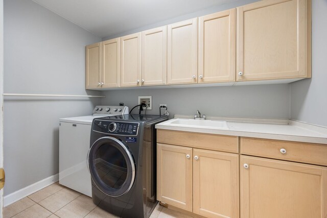 9231 N Natchez Ave, Morton Grove, IL 60053 - laundry area with cabinet space, independent washer and dryer, light tile patterned flooring, and baseboards