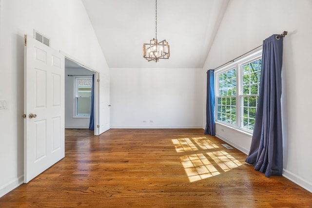 9231 N Natchez Ave, Morton Grove, IL 60053 - empty room featuring a chandelier, high vaulted ceiling, wood finished floors, and baseboards