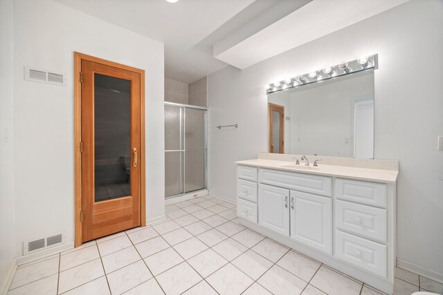 9231 N Natchez Ave, Morton Grove, IL 60053 - bathroom with a stall shower, vanity, baseboards, and tile patterned floors