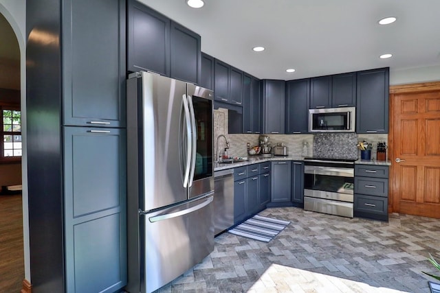 140 Princeton St, Hoffman Estates, IL 60169 - kitchen with appliances with stainless steel finishes, backsplash, arched walkways, a sink, and recessed lighting