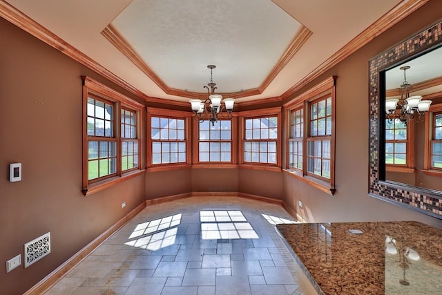140 Princeton St, Hoffman Estates, IL 60169 - unfurnished dining area featuring a chandelier, baseboards, stone tile flooring, a raised ceiling, and ornamental molding