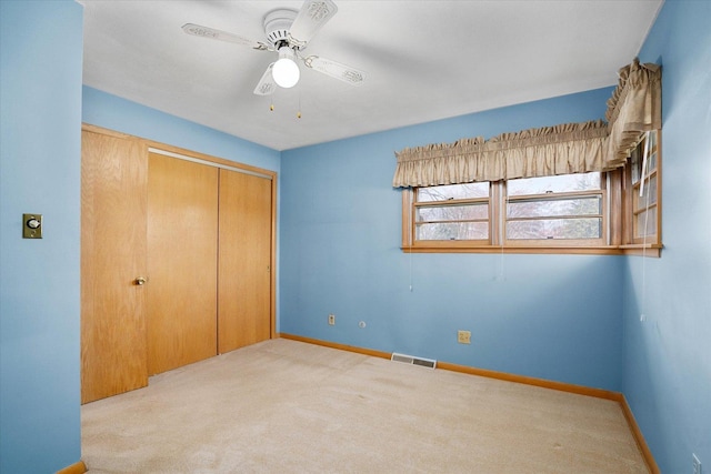 745 Konen Ave, Aurora, IL 60505 - unfurnished bedroom with carpet flooring, a closet, baseboards, and a ceiling fan