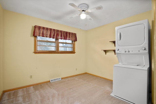 745 Konen Ave, Aurora, IL 60505 - laundry area with stacked washer / drying machine, ceiling fan, baseboards, and light colored carpet