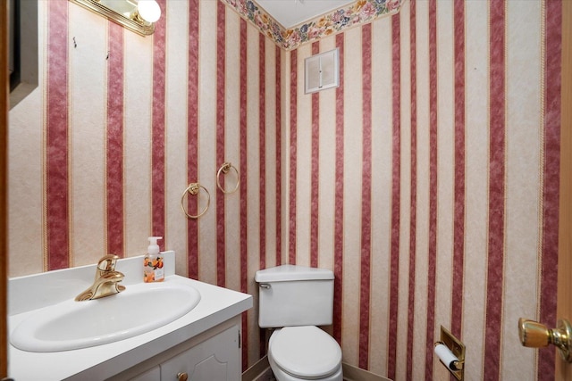 745 Konen Ave, Aurora, IL 60505 - bathroom with toilet, vanity, and wallpapered walls