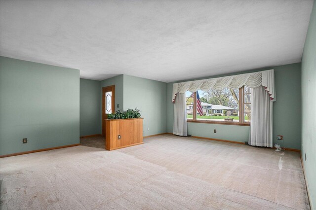 745 Konen Ave, Aurora, IL 60505 - spare room with healthy amount of natural light, carpet floors, and baseboards
