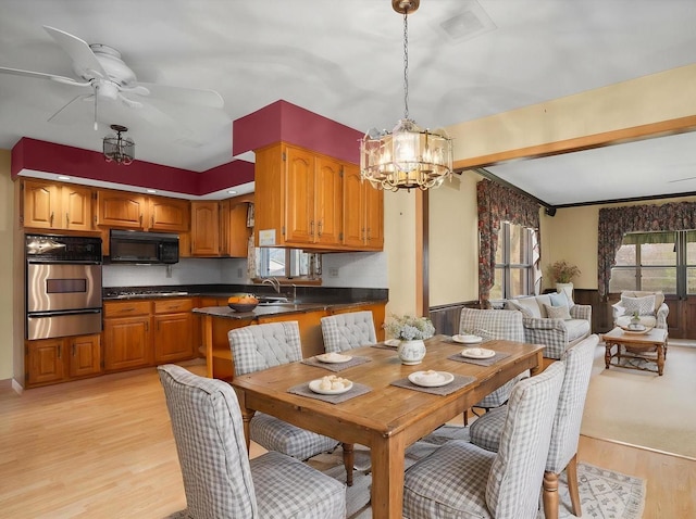 745 Konen Ave, Aurora, IL 60505 - dining room featuring light wood-style floors, a chandelier, and a ceiling fan
