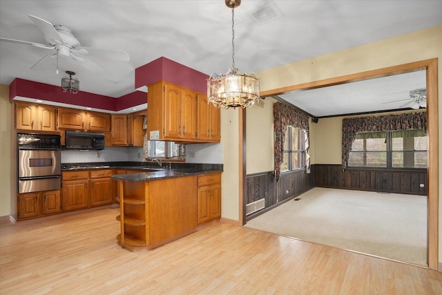 745 Konen Ave, Aurora, IL 60505 - kitchen with stainless steel appliances, a warming drawer, ceiling fan, a wainscoted wall, and brown cabinets