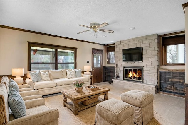 745 Konen Ave, Aurora, IL 60505 - living area featuring a fireplace, ceiling fan, healthy amount of natural light, crown molding, and a textured ceiling
