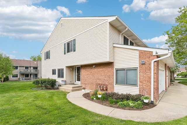 992 Hidden Lake Dr, Buffalo Grove, IL 60089 - multi unit property with an attached garage, a front lawn, brick siding, and driveway