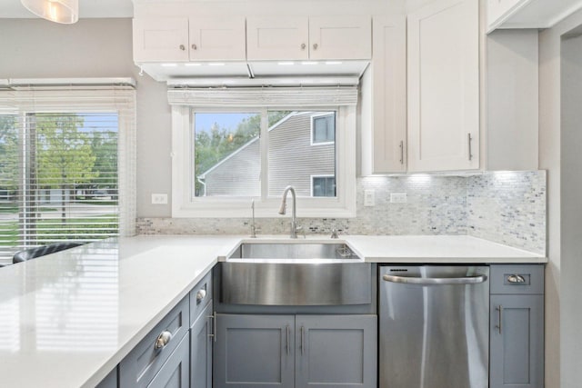 992 Hidden Lake Dr, Buffalo Grove, IL 60089 - kitchen with stainless steel dishwasher, a sink, light countertops, backsplash, and gray cabinetry