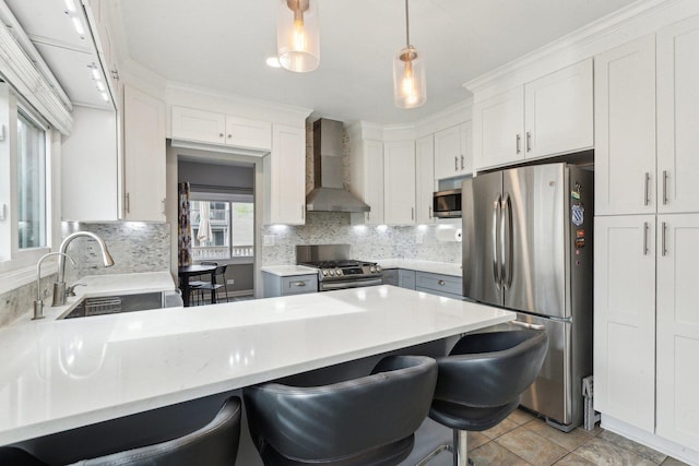 992 Hidden Lake Dr, Buffalo Grove, IL 60089 - kitchen featuring wall chimney exhaust hood, appliances with stainless steel finishes, a sink, a peninsula, and backsplash